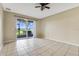Living room with tile floor, sliding glass doors to patio at 34416 Tuscany Ave, Sorrento, FL 32776