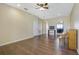 Living room with hardwood floors, piano, and view into kitchen at 34416 Tuscany Ave, Sorrento, FL 32776