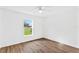 Bright bedroom featuring wood-look floors and large window at 1366 Peters Dr, Leesburg, FL 34748