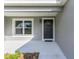 Modern dark gray front door with a wreath, welcoming entryway at 1366 Peters Dr, Leesburg, FL 34748