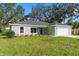 Newly built home with gray siding, white garage door, and a spacious front yard at 1366 Peters Dr, Leesburg, FL 34748