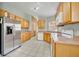 Bright kitchen with stainless steel appliances and wood cabinets at 540 Grand Canal Dr, Kissimmee, FL 34759