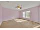 Spacious bedroom with ceiling fan and neutral walls at 540 Grand Canal Dr, Kissimmee, FL 34759
