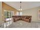Bright living room featuring a large sectional sofa and tile floors at 540 Grand Canal Dr, Kissimmee, FL 34759