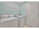 Laundry room with washer, dryer, and shelving at 540 Grand Canal Dr, Kissimmee, FL 34759