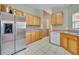Bright kitchen with stainless steel appliances and wood cabinets at 540 Grand Canal Dr, Kissimmee, FL 34759