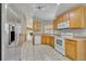 Bright kitchen with stainless steel appliances and wood cabinets at 540 Grand Canal Dr, Kissimmee, FL 34759