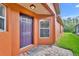 Exterior view of house entrance with purple door and brick walkway at 540 Grand Canal Dr, Kissimmee, FL 34759