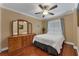Bright bedroom with wood floors, dresser, and comfortable bed at 13129 Coldwater Loop, Clermont, FL 34711