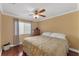 Spacious bedroom with wood floors and a ceiling fan at 13129 Coldwater Loop, Clermont, FL 34711