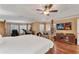 Main bedroom with king-size bed, a TV, and a relaxing seating area at 13129 Coldwater Loop, Clermont, FL 34711