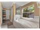 Relaxing bathroom with a soaking tub, shower, and a large window at 13129 Coldwater Loop, Clermont, FL 34711