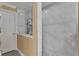 Elegant shower with marble tile and modern fixtures at 13129 Coldwater Loop, Clermont, FL 34711