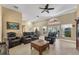 Spacious living room featuring comfortable leather seating and a large entertainment center at 13129 Coldwater Loop, Clermont, FL 34711