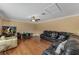 Spacious living room with hardwood floors, comfortable seating, and large TV at 13129 Coldwater Loop, Clermont, FL 34711