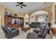 Open living room with ample seating, a large TV, and access to other areas at 13129 Coldwater Loop, Clermont, FL 34711