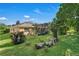 Landscaped backyard with lush greenery and a large tree trunk at 13129 Coldwater Loop, Clermont, FL 34711