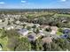 Aerial view of a residential neighborhood showcasing houses, streets, and green spaces at 13129 Coldwater Loop, Clermont, FL 34711