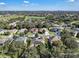 Aerial view of a residential neighborhood with houses and lush green trees at 13129 Coldwater Loop, Clermont, FL 34711