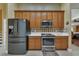 Modern kitchen with stainless steel appliances and wood cabinets at 13129 Coldwater Loop, Clermont, FL 34711