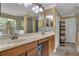 Double vanity bathroom with a large mirror, shower, and linen storage at 13129 Coldwater Loop, Clermont, FL 34711