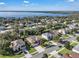 Aerial view of a lakefront residential neighborhood with houses and lush green trees at 13129 Coldwater Loop, Clermont, FL 34711