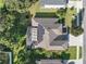 Top-down view of a house with solar panels and a screened enclosure at 13129 Coldwater Loop, Clermont, FL 34711
