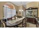 Elegant dining room with large table, hutch, and arched window at 13129 Coldwater Loop, Clermont, FL 34711