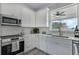 Bright kitchen featuring white shaker cabinets and quartz countertops at 12332 Basin St, Clermont, FL 34715