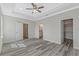 Main bedroom with wood-look floors and access to en-suite bathroom and closet at 12332 Basin St, Clermont, FL 34715