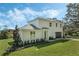 A two-story house with a modern exterior, attached garage, and beautifully landscaped yard at 12332 Basin St, Clermont, FL 34715