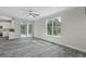 Living room with gray plank flooring and sliding glass doors at 12332 Basin St, Clermont, FL 34715
