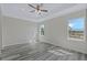Bright bedroom with hardwood floors and two windows providing natural light at 12332 Basin St, Clermont, FL 34715