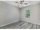 Bright bedroom features grey flooring and a large window at 12332 Basin St, Clermont, FL 34715