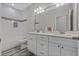 Clean bathroom with white double vanity and a bathtub at 12332 Basin St, Clermont, FL 34715