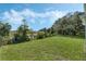 Spacious backyard with lush grass and pond view at 12332 Basin St, Clermont, FL 34715