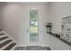 Bright and airy entryway with wood-look floors, white walls, and a charming decor at 12332 Basin St, Clermont, FL 34715