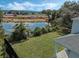 Pond view from the backyard with a house and highway in the background at 12332 Basin St, Clermont, FL 34715