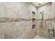 Elegant shower with neutral tile and built-in shelves at 8222 Florida Boys Ranch Rd, Groveland, FL 34736