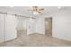 Spacious bedroom with tile floors and barn doors at 8222 Florida Boys Ranch Rd, Groveland, FL 34736