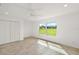Bright bedroom with tile floors and large window offering a view of the backyard at 8222 Florida Boys Ranch Rd, Groveland, FL 34736