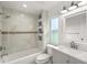 Modern bathroom with marble tile, bathtub and vanity at 8222 Florida Boys Ranch Rd, Groveland, FL 34736