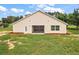 Tan house exterior with screened porch and landscaped yard at 8222 Florida Boys Ranch Rd, Groveland, FL 34736