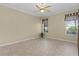 Well-lit bedroom with neutral walls, wood flooring, and window views at 25304 Forest Oak Ct, Leesburg, FL 34748