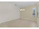 Simple dining room with a chandelier and neutral wall colors at 25304 Forest Oak Ct, Leesburg, FL 34748