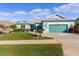 Beautiful teal home with landscaping and driveway at 25304 Forest Oak Ct, Leesburg, FL 34748