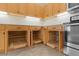Kitchen with wood cabinets and pull-out shelves at 25304 Forest Oak Ct, Leesburg, FL 34748