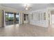 Bright living room featuring sliding glass doors and built-in shelving at 25304 Forest Oak Ct, Leesburg, FL 34748