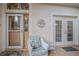 Front porch with seating area and double French doors at 6062 Armada St, Tavares, FL 32778