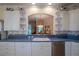 Bright kitchen features white cabinets, blue countertops, and a pass-through to the dining area at 6062 Armada St, Tavares, FL 32778
